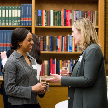 Two UCD alumnae networking at an event.